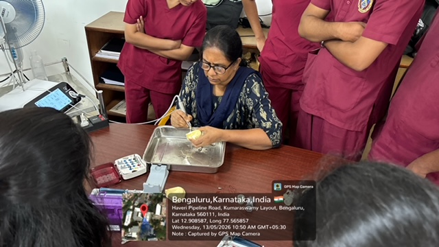 Faculty demonstrating dummy implant placement on a model